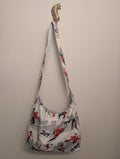 Reversible handmade shoulder bag shown with the superhero-print side out