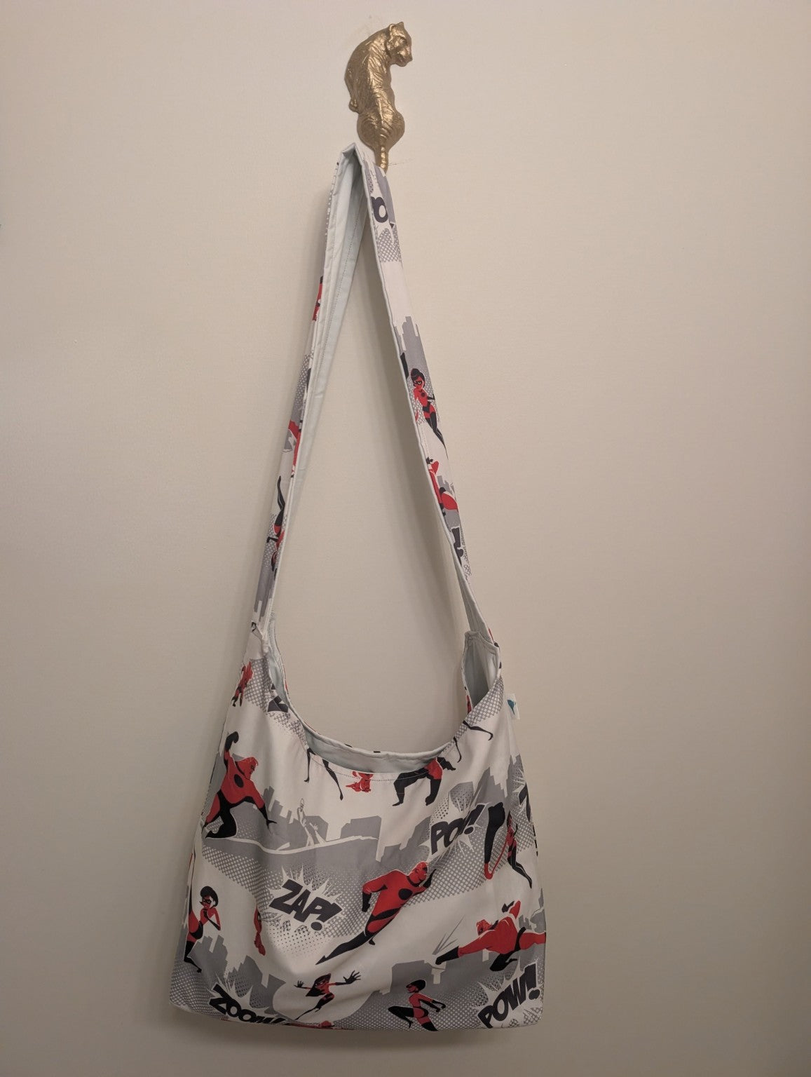 Reversible handmade shoulder bag shown with the superhero-print side out